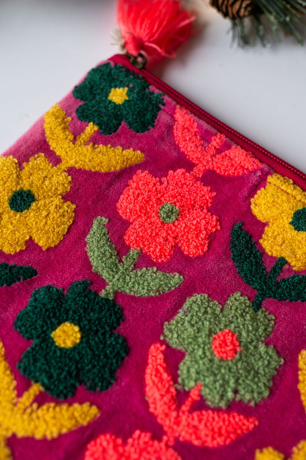 Velvet Multi Flower pattern pouch with stitched detail and tassel on zip